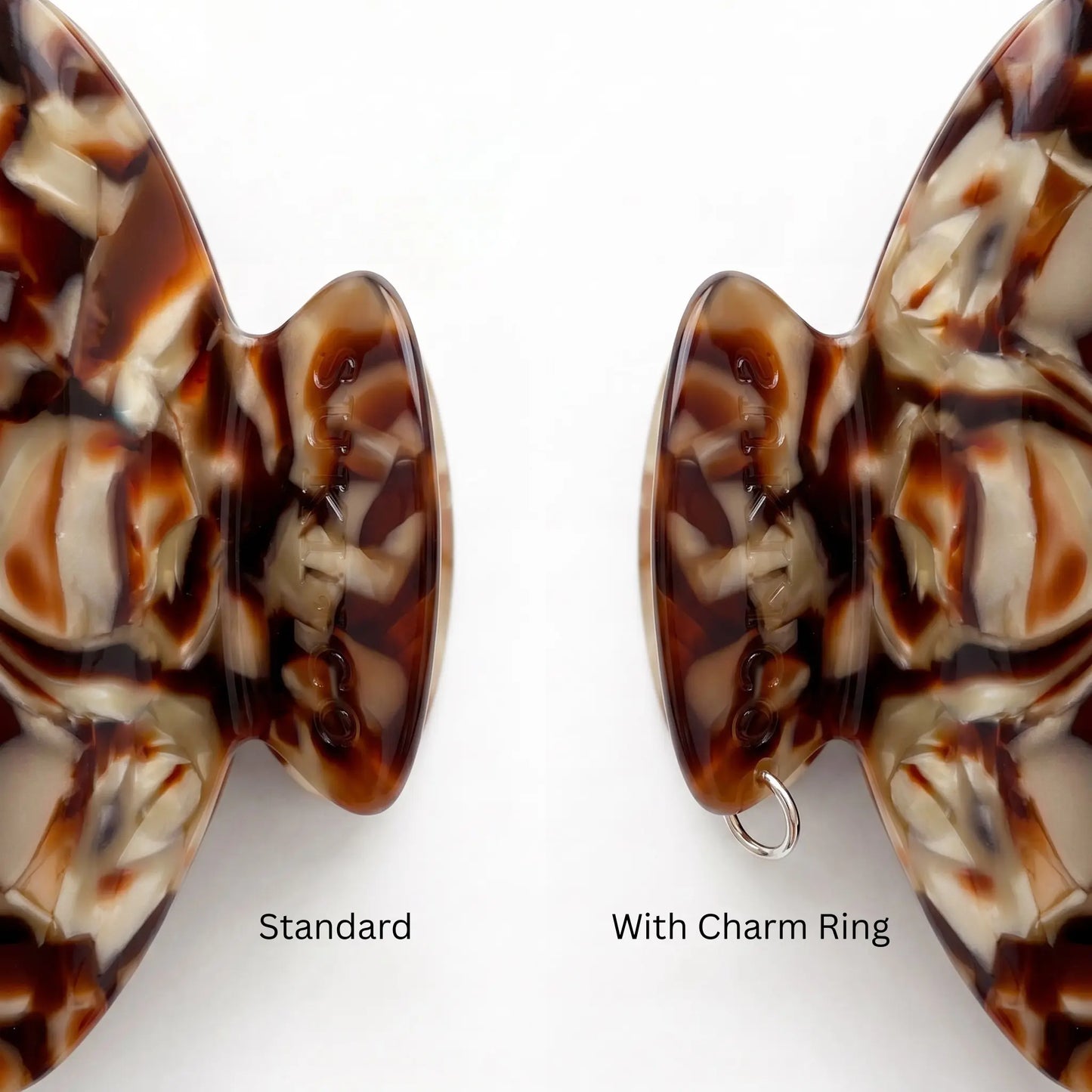 Two close up views of a tortoiseshell  hair claw clip handle on a white background, labeled 'Standard' and 'With Charm Ring' to show the included silver ring attachment charm.