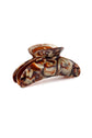 A tortoiseshell hair claw clip with a marbled pattern of brown, amber, and silver, shown on a clean white background.